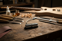 Noiseless Tele P bass pickup on a luthier’s workbench.